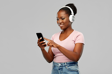 Image showing african woman in headphones listening to music