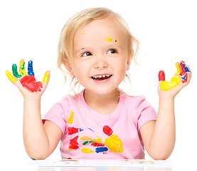 Image showing Portrait of a cute little girl playing with paints