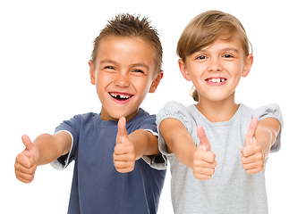 Image showing Little boy and girl are showing thumb up sign