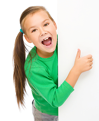 Image showing Little girl is looking from out blank board