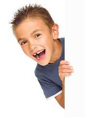 Image showing Little boy is looking out from the blank banner