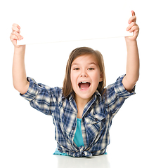 Image showing Little girl is holding a blank banner