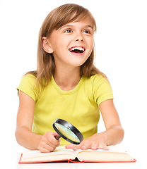 Image showing Little girl is reading book