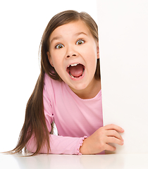 Image showing Little girl is looking from out blank board