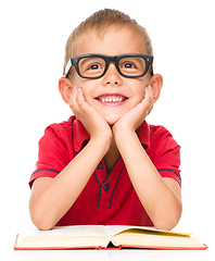 Image showing Little boy is reading a book