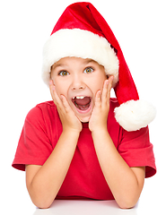 Image showing Little girl is holding her face in astonishment