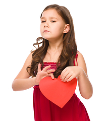 Image showing Portrait of a sad little girl in red