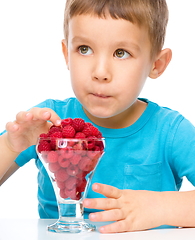 Image showing Little boy with raspberries