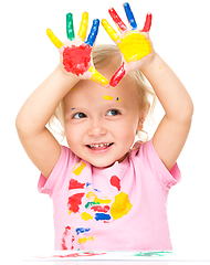 Image showing Portrait of a cute little girl playing with paints