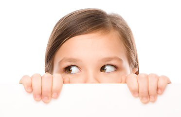 Image showing Little girl is looking from out blank board