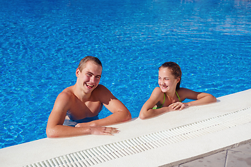 Image showing boy and girl having fun in swimming pool