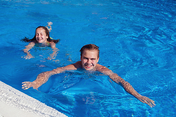 Image showing boy and girl having fun in swimming pool