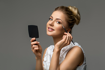 Image showing beautiful girl applying makeup