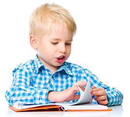 Image showing Little child play with book