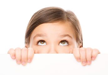 Image showing Little girl is looking from out blank board