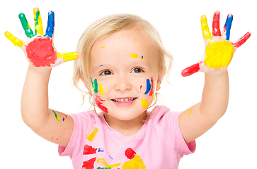 Image showing Portrait of a cute little girl playing with paints