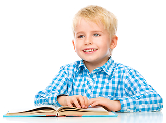 Image showing Little child play with book