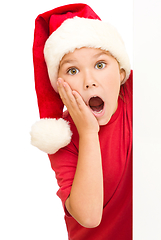 Image showing Little girl is holding her face in astonishment