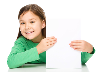 Image showing Little girl is looking from out blank board