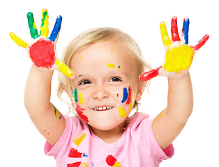 Image showing Portrait of a cute little girl playing with paints