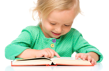 Image showing Little girl is reading her book