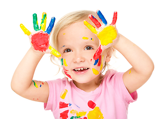 Image showing Portrait of a cute little girl playing with paints