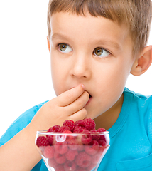 Image showing Little boy with raspberries