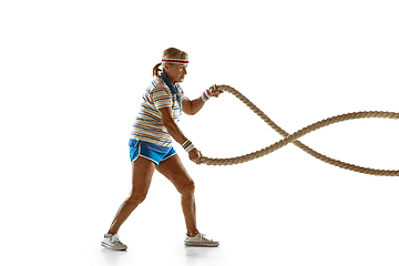 Image showing Senior woman training with ropes in sportwear on white background