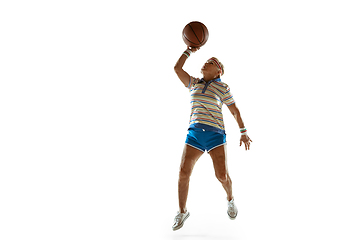 Image showing Senior woman playing basketball in sportwear on white background