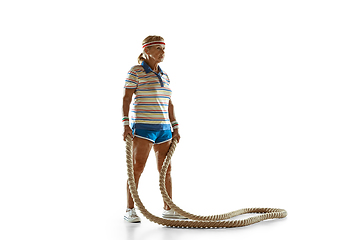 Image showing Senior woman training with ropes in sportwear on white background