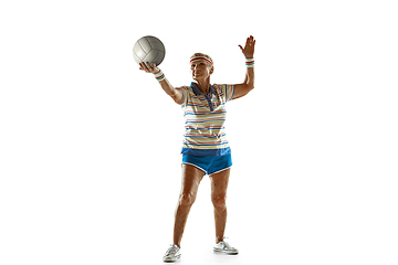 Image showing Senior woman playing volleyball in sportwear on white background