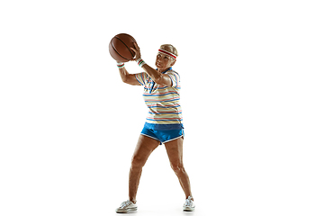 Image showing Senior woman playing basketball in sportwear on white background