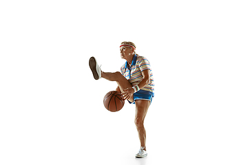 Image showing Senior woman playing basketball in sportwear on white background