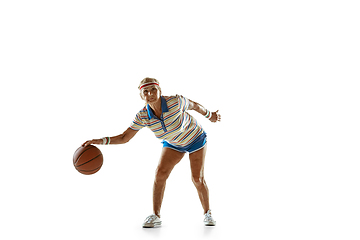 Image showing Senior woman playing basketball in sportwear on white background