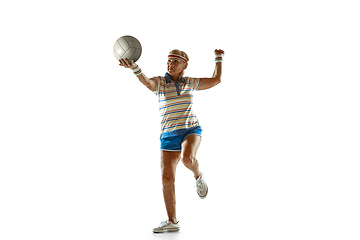 Image showing Senior woman playing volleyball in sportwear on white background