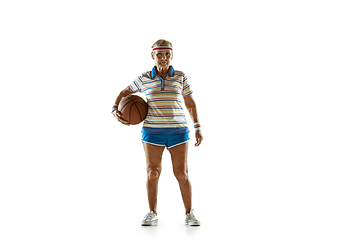 Image showing Senior woman playing basketball in sportwear on white background