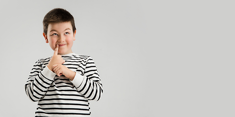 Image showing Caucasian boy isolated on white studio background. Copyspace. Childhood, education, emotions concept