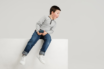 Image showing Caucasian boy isolated on white studio background. Copyspace. Childhood, education, emotions concept