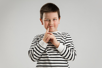 Image showing Caucasian boy isolated on white studio background. Copyspace. Childhood, education, emotions concept