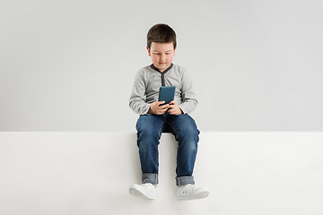 Image showing Caucasian boy isolated on white studio background. Copyspace. Childhood, education, emotions concept