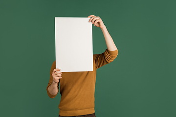 Image showing Caucasian man\'s portrait isolated over green studio background with copyspace