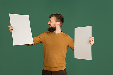 Image showing Caucasian man\'s portrait isolated over green studio background with copyspace