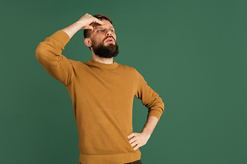 Image showing Caucasian man\'s portrait isolated over green studio background with copyspace