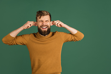 Image showing Caucasian man\'s portrait isolated over green studio background with copyspace