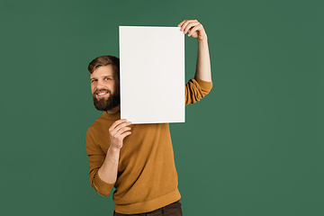 Image showing Caucasian man\'s portrait isolated over green studio background with copyspace