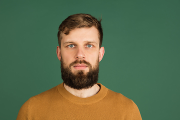 Image showing Caucasian man\'s portrait isolated over green studio background with copyspace