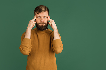 Image showing Caucasian man\'s portrait isolated over green studio background with copyspace