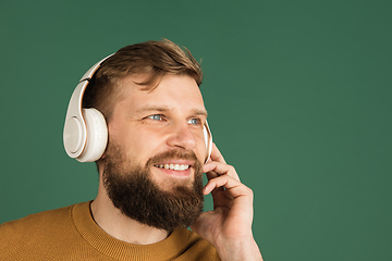 Image showing Caucasian man\'s portrait isolated over green studio background with copyspace