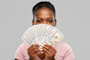 Image showing african american woman hiding behind dollar money