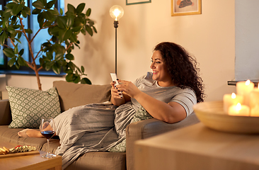 Image showing woman with smartphone at home in evening